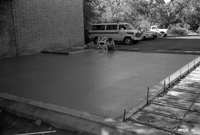 Men preparing foundation for cement during construction of headquarters addition.