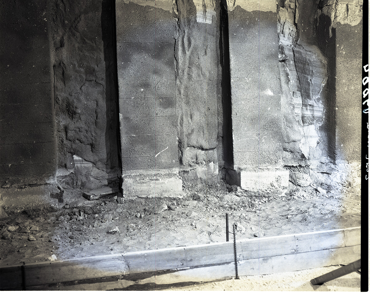 Shattered condition of tunnel wall, illustrating need for repair and danger of work of removing debris from footings.