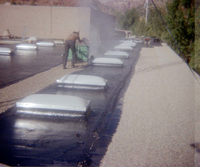 Man pushing roofing hand cart during the headquarters/visitor center roofing project.