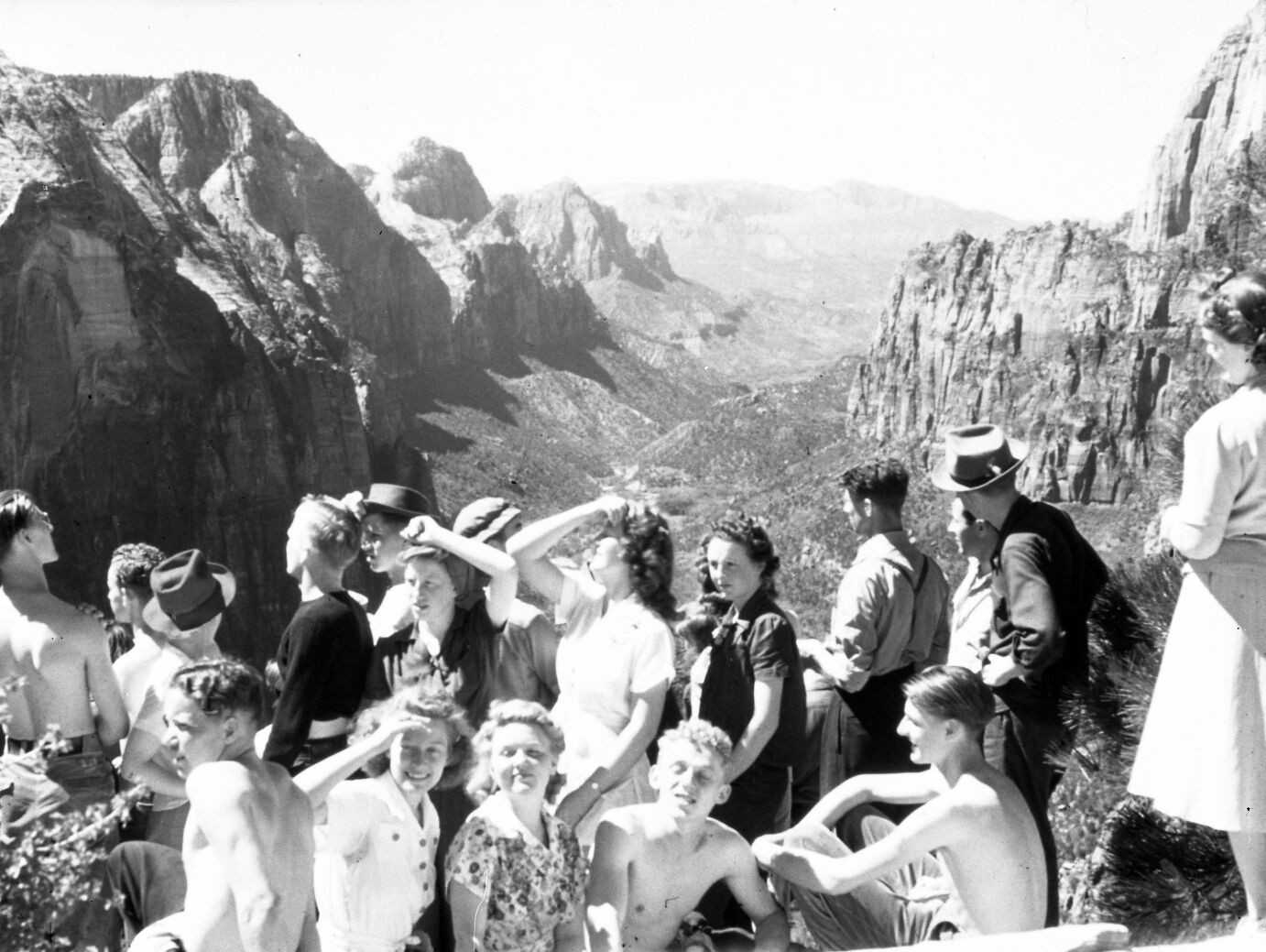 A group of hikers on Angels Landing, with view down Zion Canyon.