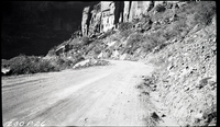 Road construction looking toward red point on Zion Canyon road. Note large boulder above road in background.