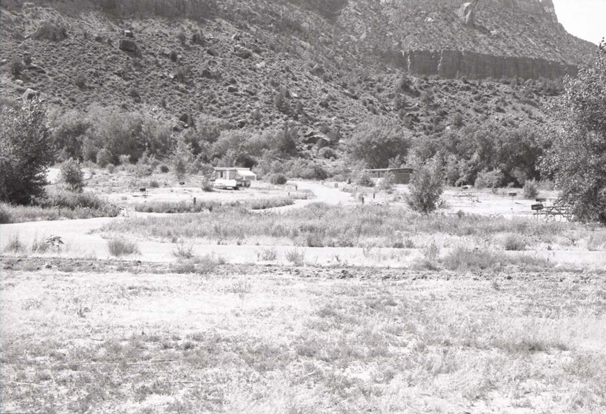 Camping sites with one trailer filling a spot in Watchman Campground.