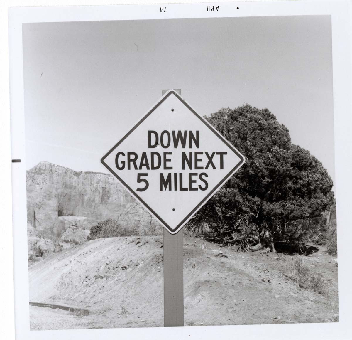 Road sign reading 'Down Grade Next 5 Miles' in Kolob Canyon.