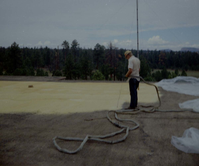 Man spraying foam sealant during reroofing project. Bryce Canyon National Park.
