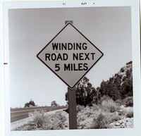 Road sign reading 'Winding Road Next 5 Miles' in Kolob Canyon.