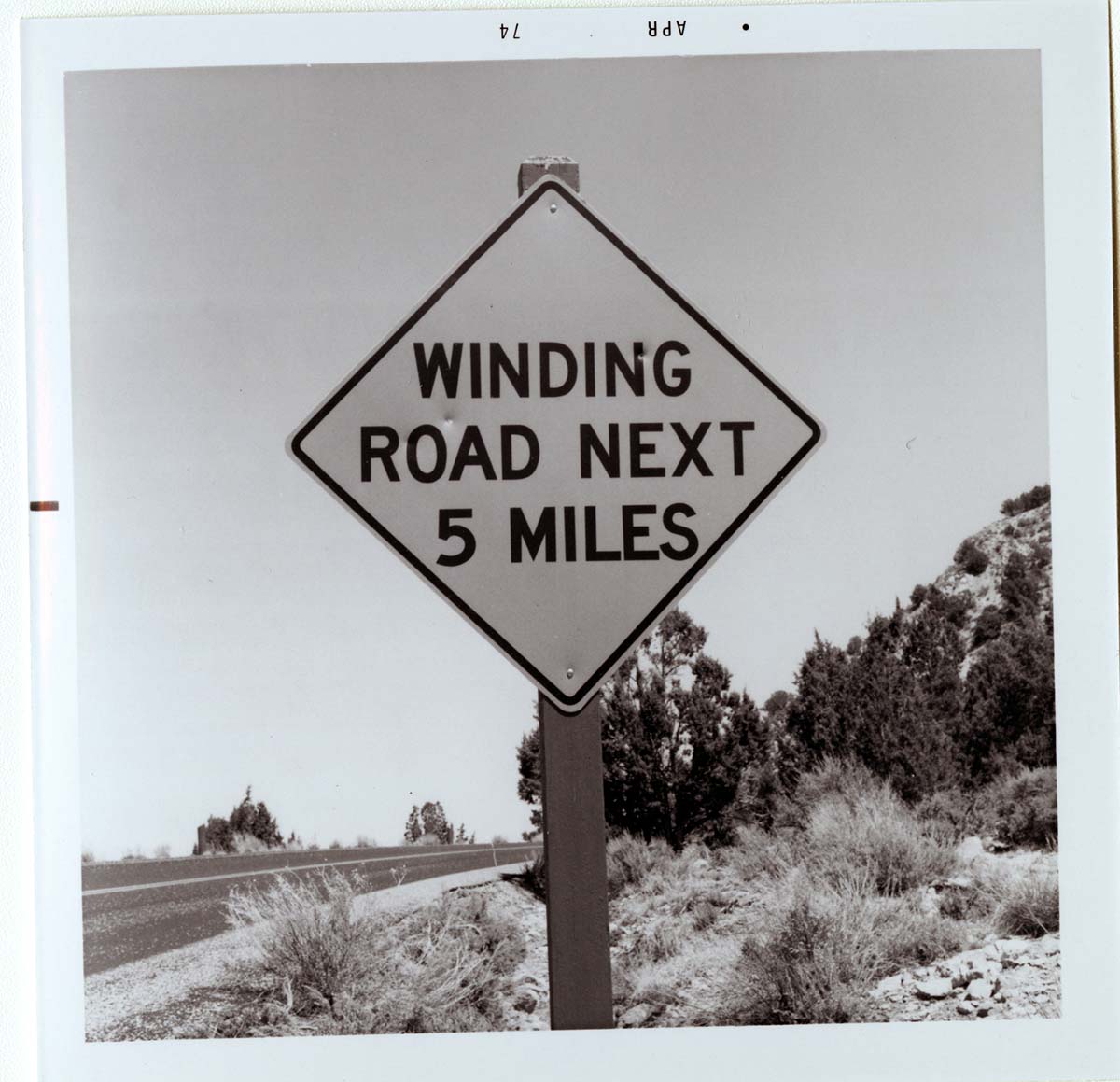 Road sign reading 'Winding Road Next 5 Miles' in Kolob Canyon.