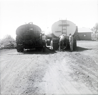 Men working on construction vehicles during chipsealing of Kolob Canyon Road.