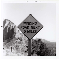 Road sign reading 'Winding Road Next 5 Miles' in Kolob Canyon.
