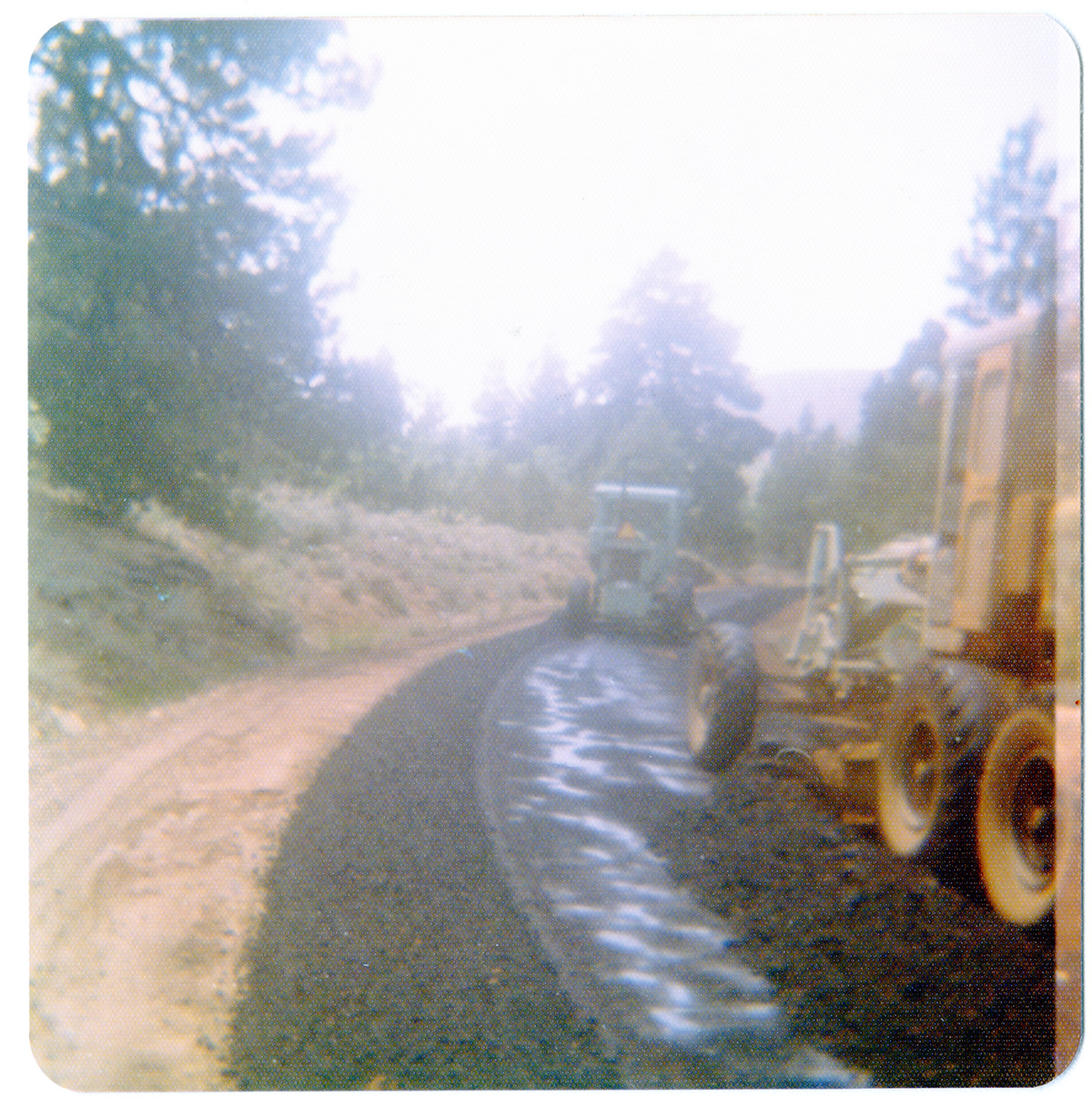 Construction vehicles laying asphalt during road work along the Kolob Terrace Road.