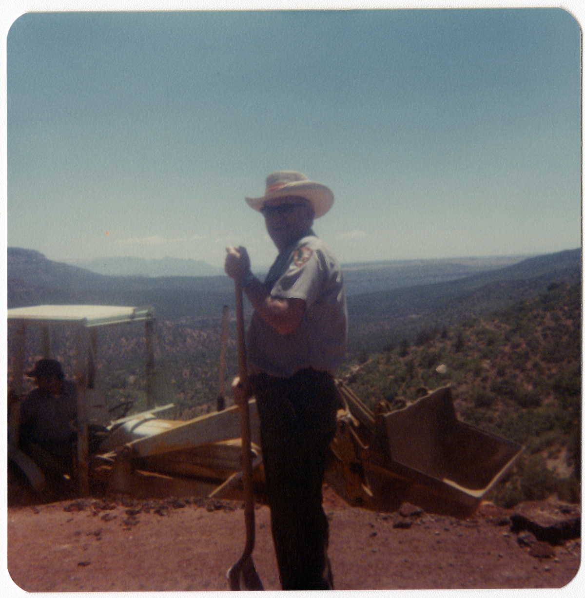 Park ranger standing with shovel during road work/repair in Kolob Canyon.