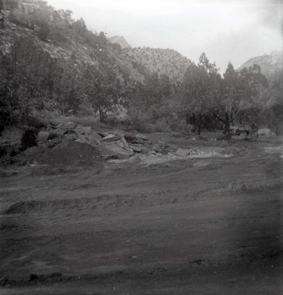Dirt road with rock piles along the scenic canyon drive near the Grotto during construction.