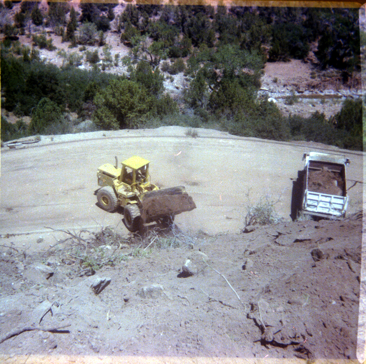 View from above of construction vehicles working on road repair in Kolob Canyon.