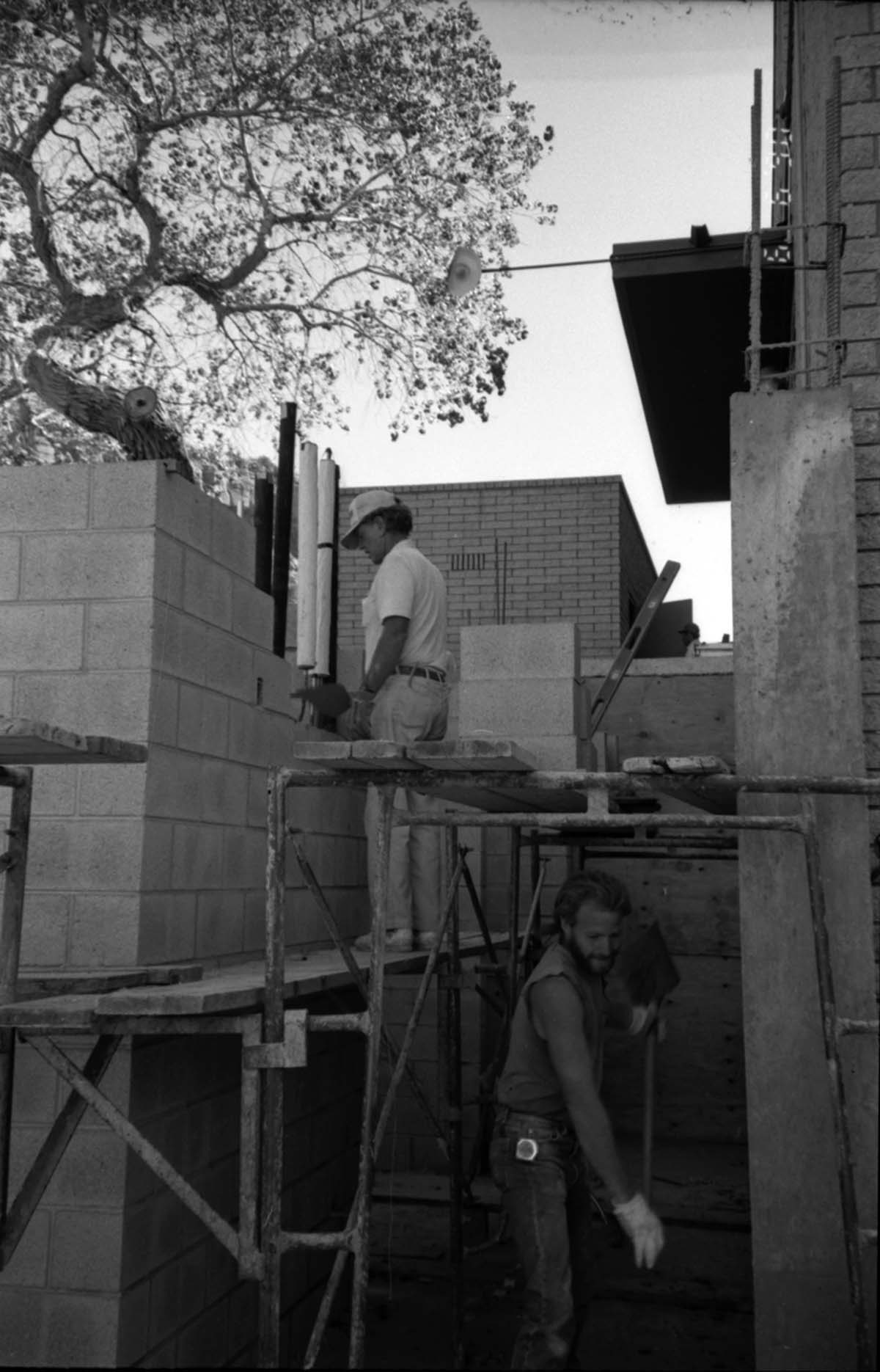 Workers working during the construction of headquarters addition.