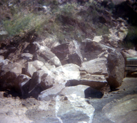 Color Photo of a rock slide along road.