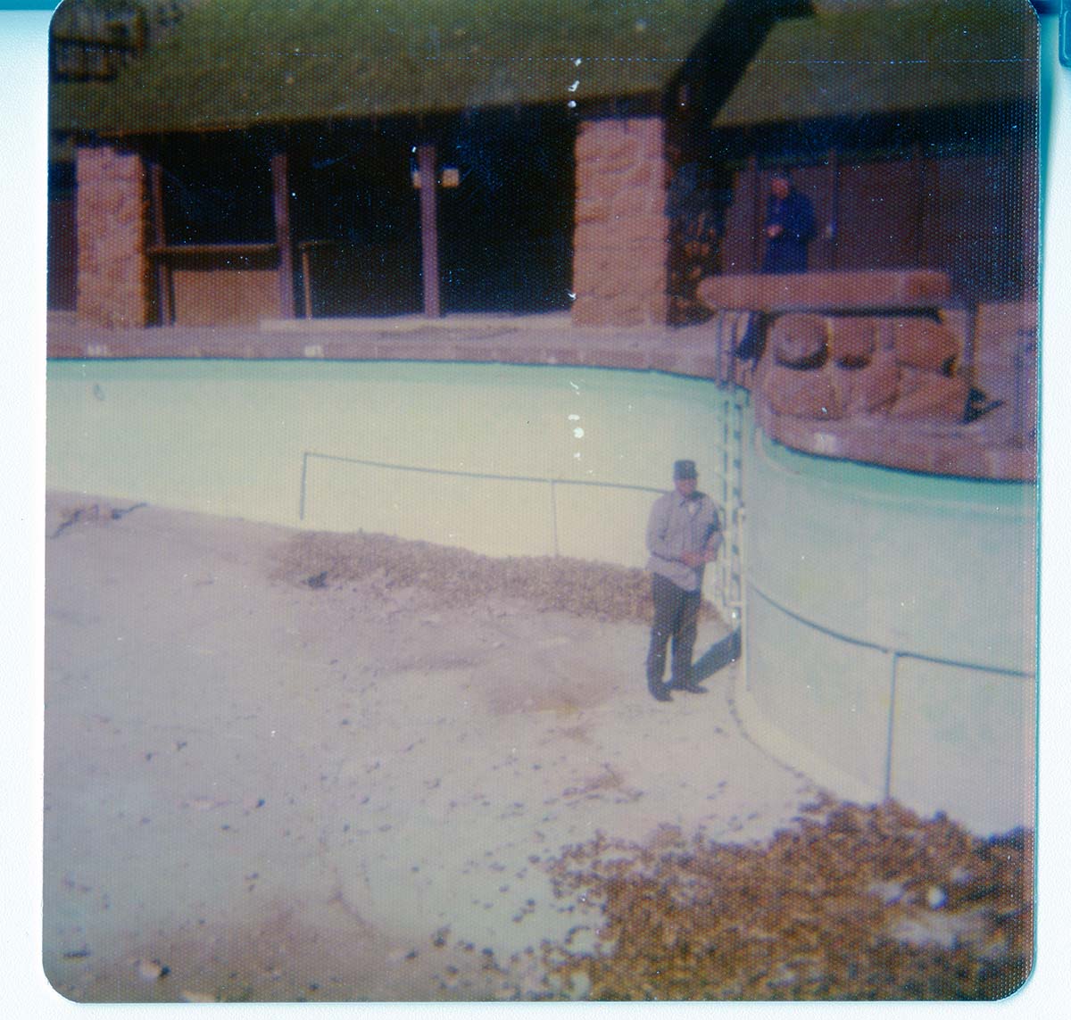 Workers preparing for the destruction of the lodge pool and bathhouse.