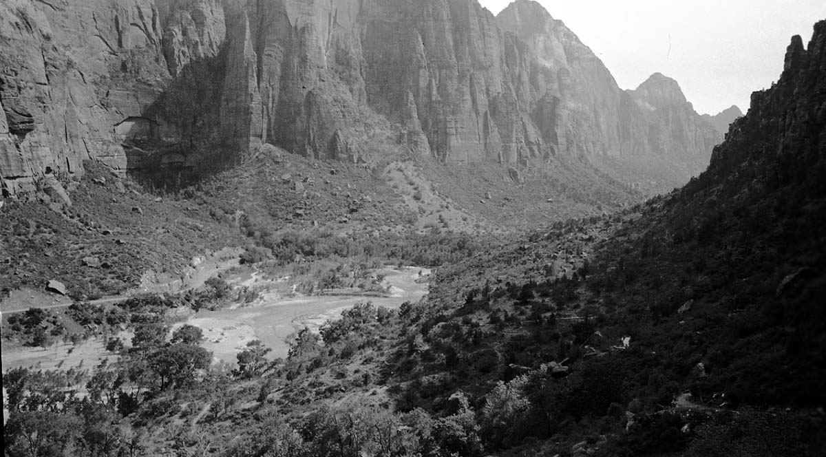 Zion Canyon, Mountain of the Sun, Bridge Mountain rising above the Virgin River and the canyon floor. The canyon road is visible.