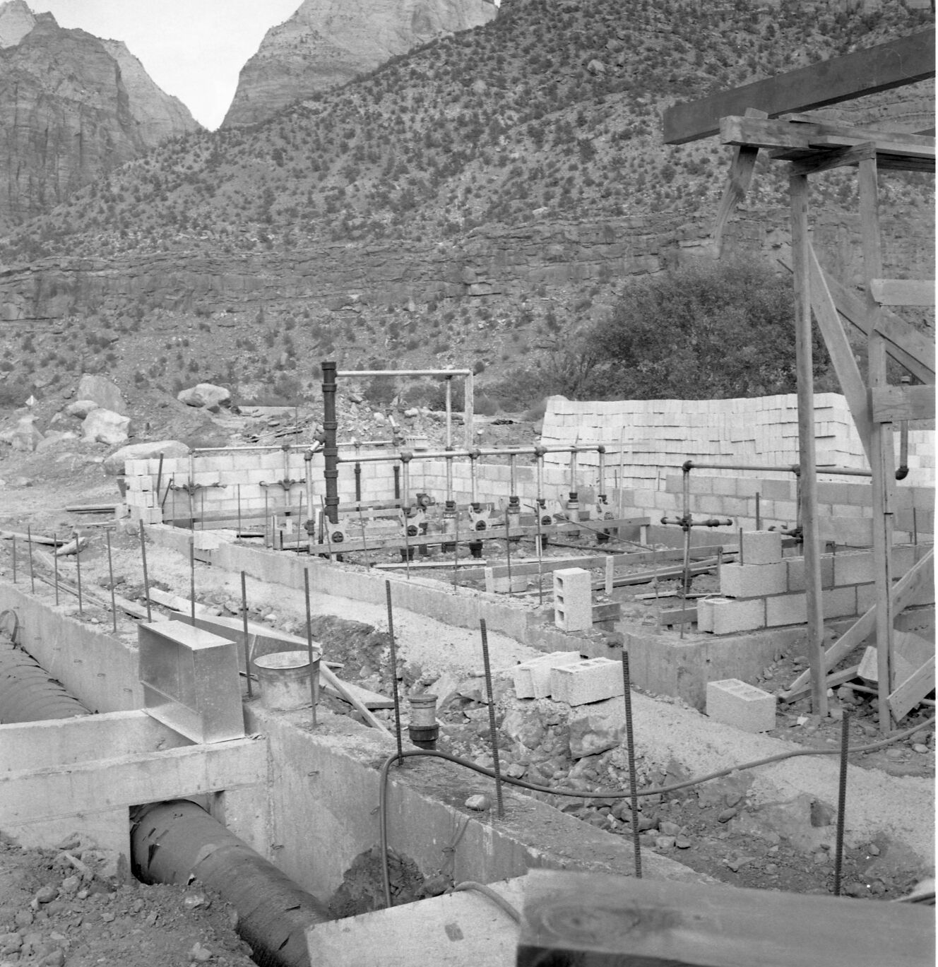 First split block laid and the start of walls for Mission 66 Visitor Center and Museum comfort station and visitor center construction.