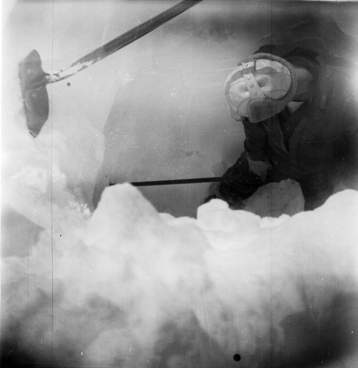 BW Photos showing rangers digging out the visitor center from snowdrift.