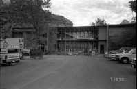 Vehicles parked in the parking lot and the new addition of headquarters during construction.