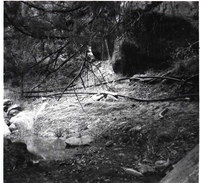 Spring and pond with pipe near base of canyon wall. [Birch Creek]