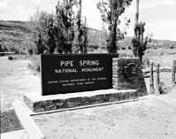 The sign in front of the new Tribal and National Park Service Visitor Center at time of the dedication ceremony and the 50th anniversary celebration of the monument. Sign reads: Pipe Spring National Monument Kaibab-Paiute Indian Tribe.