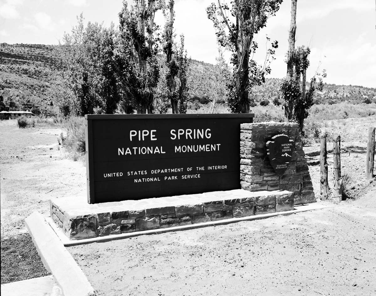 The sign in front of the new Tribal and National Park Service Visitor Center at time of the dedication ceremony and the 50th anniversary celebration of the monument. Sign reads: Pipe Spring National Monument Kaibab-Paiute Indian Tribe.