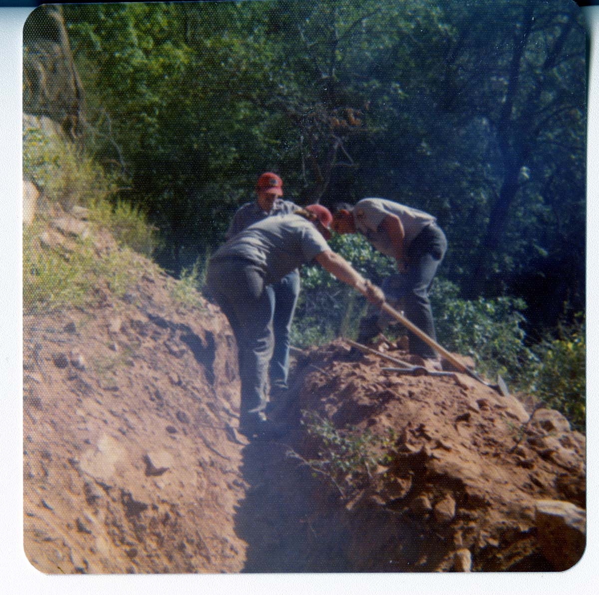 Workers excavating ditch.