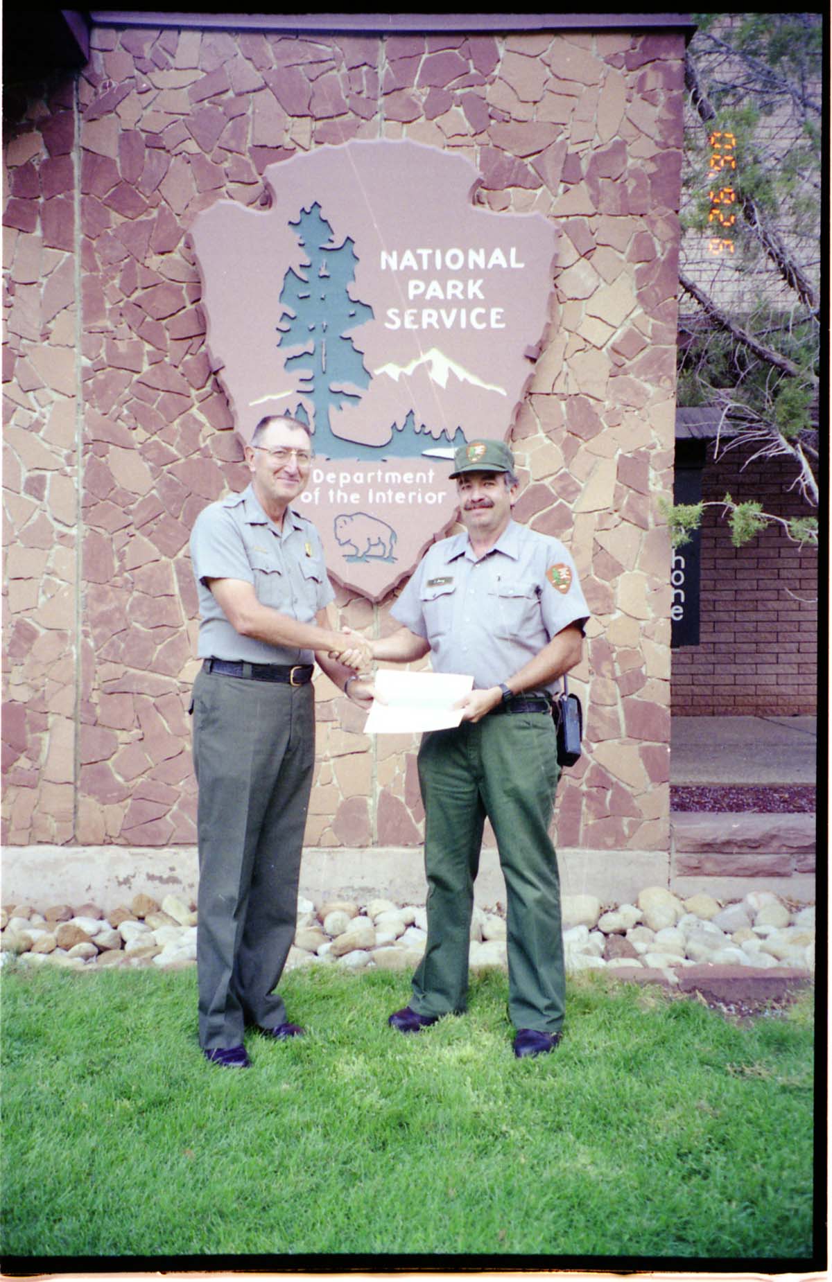 Color Photos of Superintendent Harold Grafe giving out awards to park personnel.