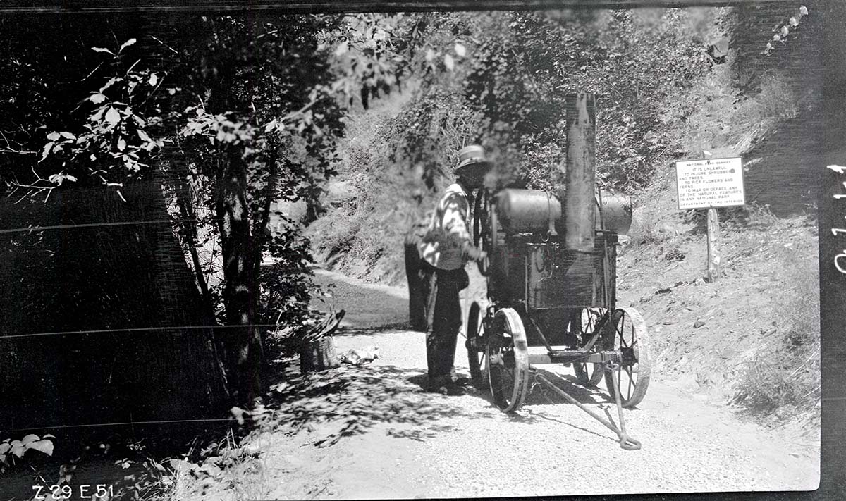 Narrows Trail construction with worker operating the oil heater used in spraying on the bitumuls 50.