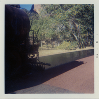 Sealcoating tank laying down sealcoat on road.