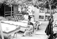 State Emergency Relief Administration (SERA) and Civilian Conservation Corps (CCC) workers outdoors 'pointing up' relief maps of Zion and other parks.