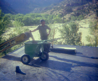 Man standing by as the roofing cart is filled with roofing materials during the headquarters/visitor center roofing project.