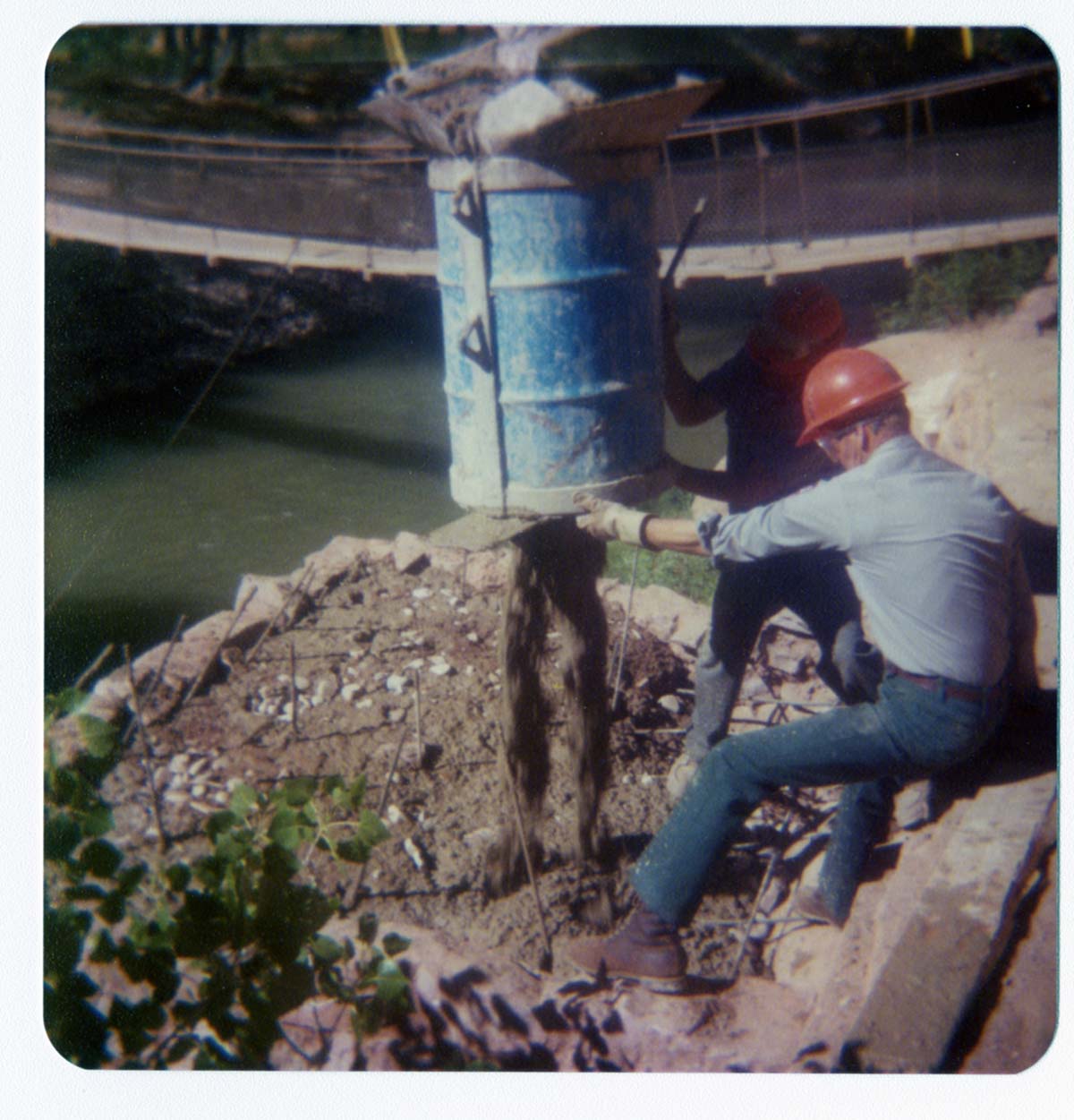 Workers pouring cement during the arrival and emplacement of three new footbridges in Zion Canyon.