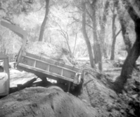 Construction vehicle dumping soil during the clearing/cleaning and setting up of the lodge spray field.