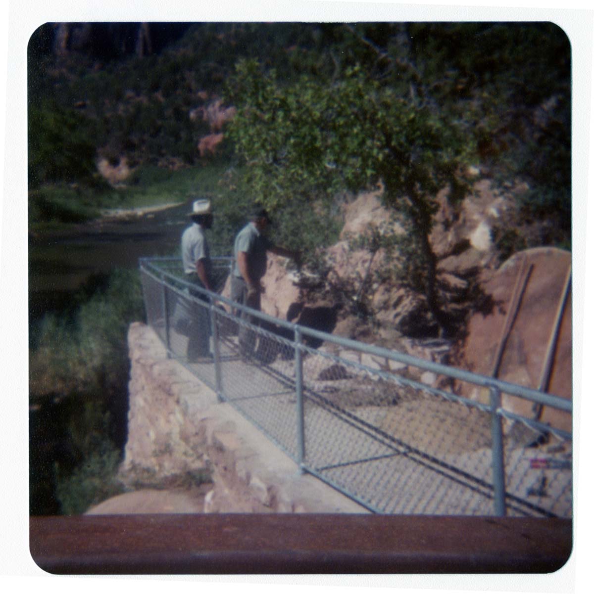Men working on trail by the new Grotto footbridge.