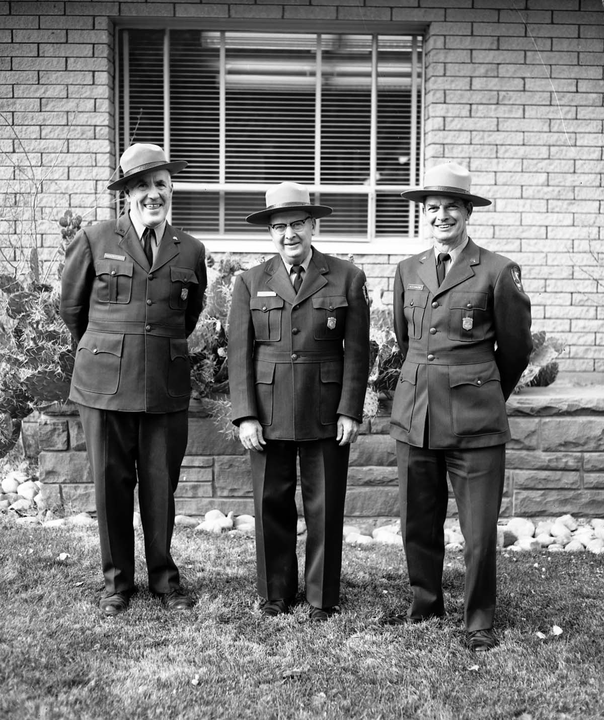 Rudy Lueck (left) and Carl E. Jepson (center) at time of their retirement standing with Superintendent Warren F. Hamilton (right). Mission 66 Visitor Center and Museum and headquarters.