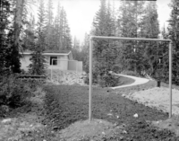 Backyard of multiplex during landscaping in the residential area. Clothesline and picnic table amid the tilled soil.