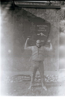 Man with beard flexing muscles.