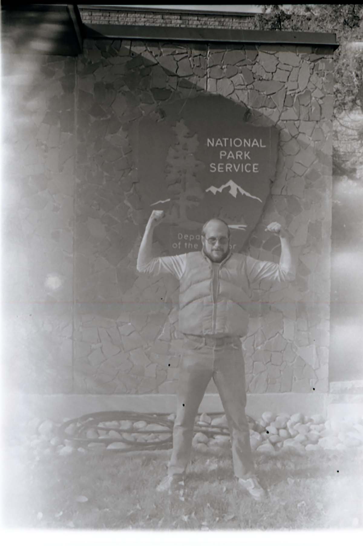 Man with beard flexing muscles.