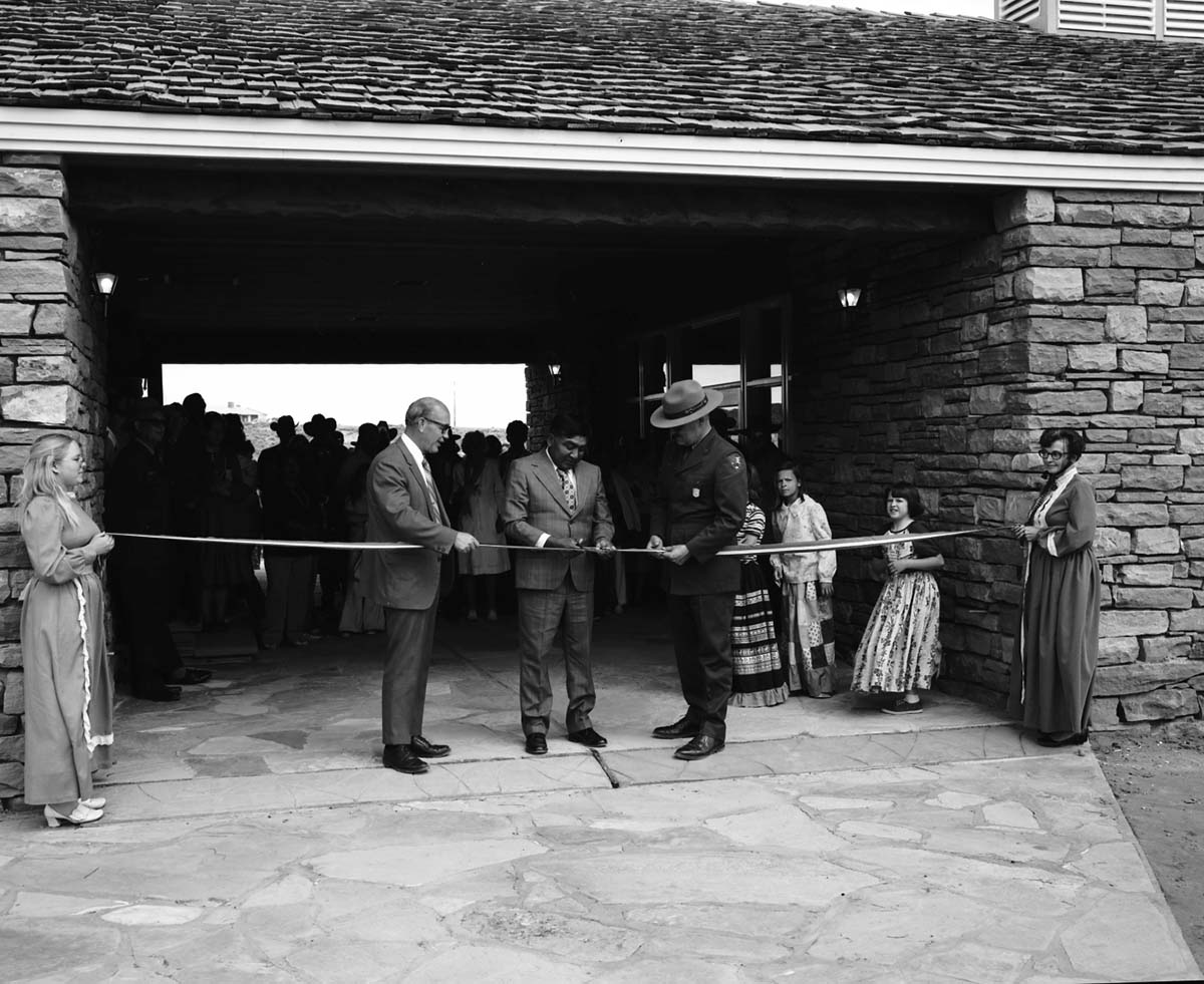 Kaibab-Paiute Tribal Council Chairman Bill Tom cuts the ribbon with National Park Service Midwest Regional Director J. Leonard Volz and Zion Superintendent Robert C. Heyder at the dedication of new Tribal and National Park Service Visitor Center and 50th anniversary at Pipe Spring National Monument.
