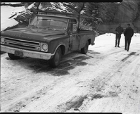 Snowplow accident, county line curve along East Entrance road showing vehicle that slid into snow plow and skid marks.