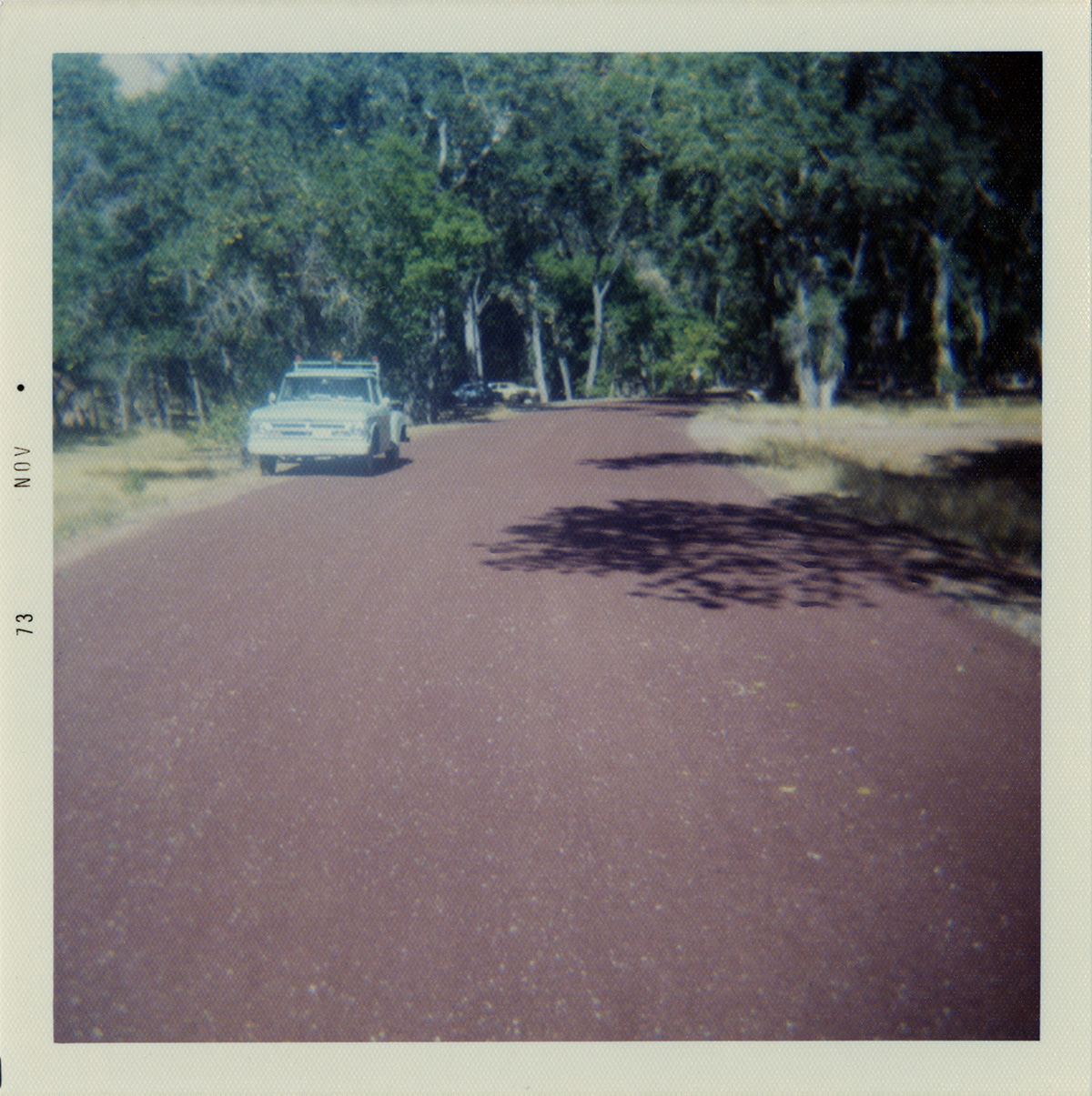 Road with construction vehicle pulled off to side during road repairs.