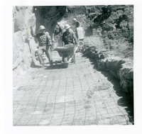 Workers operating construction equipment during the West Rim trail half tunnel maintenance/stabilization.