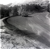Truck driving down the road during east side road repair and turn out construction.