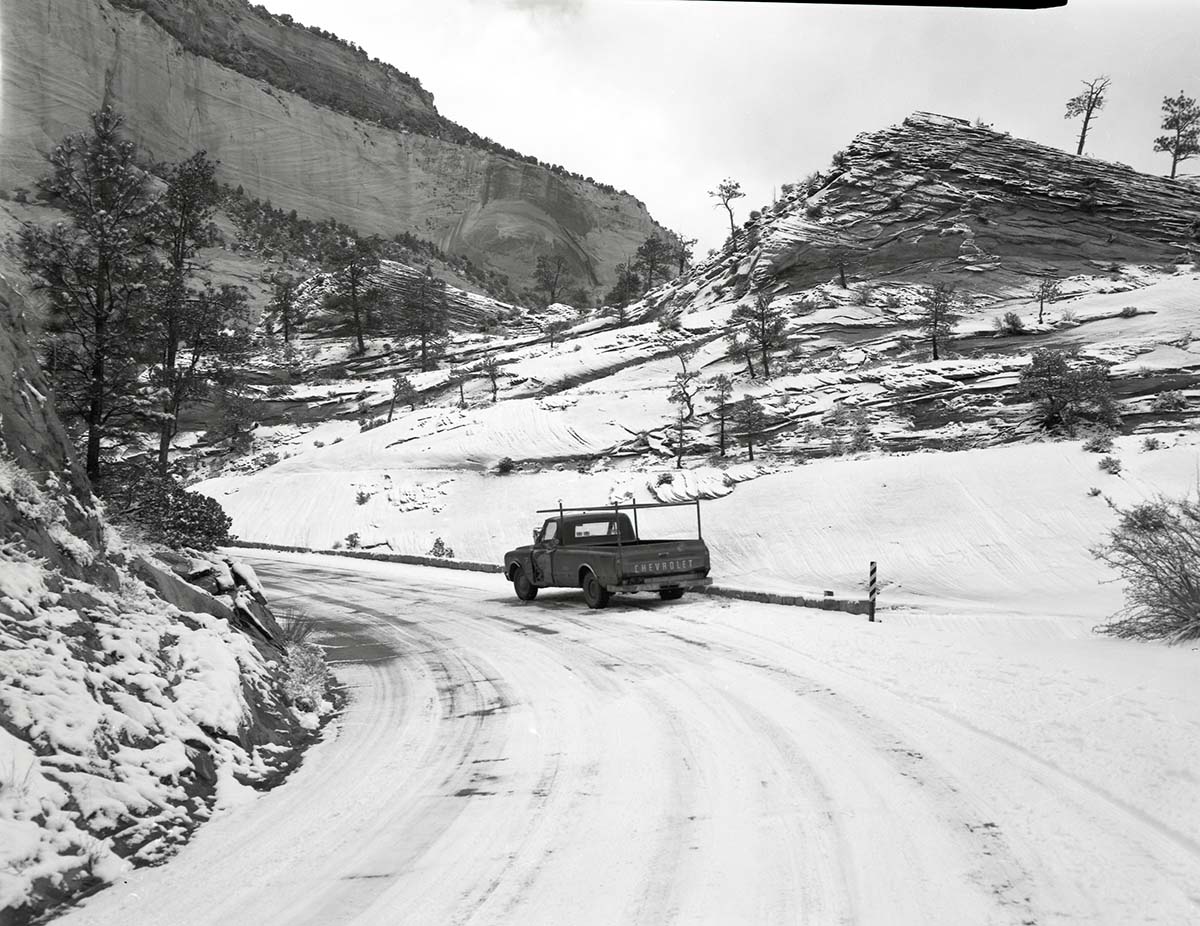 Snowplow accident, county line curve along East Entrance road showing vehicle that slid into snow plow and skid marks.