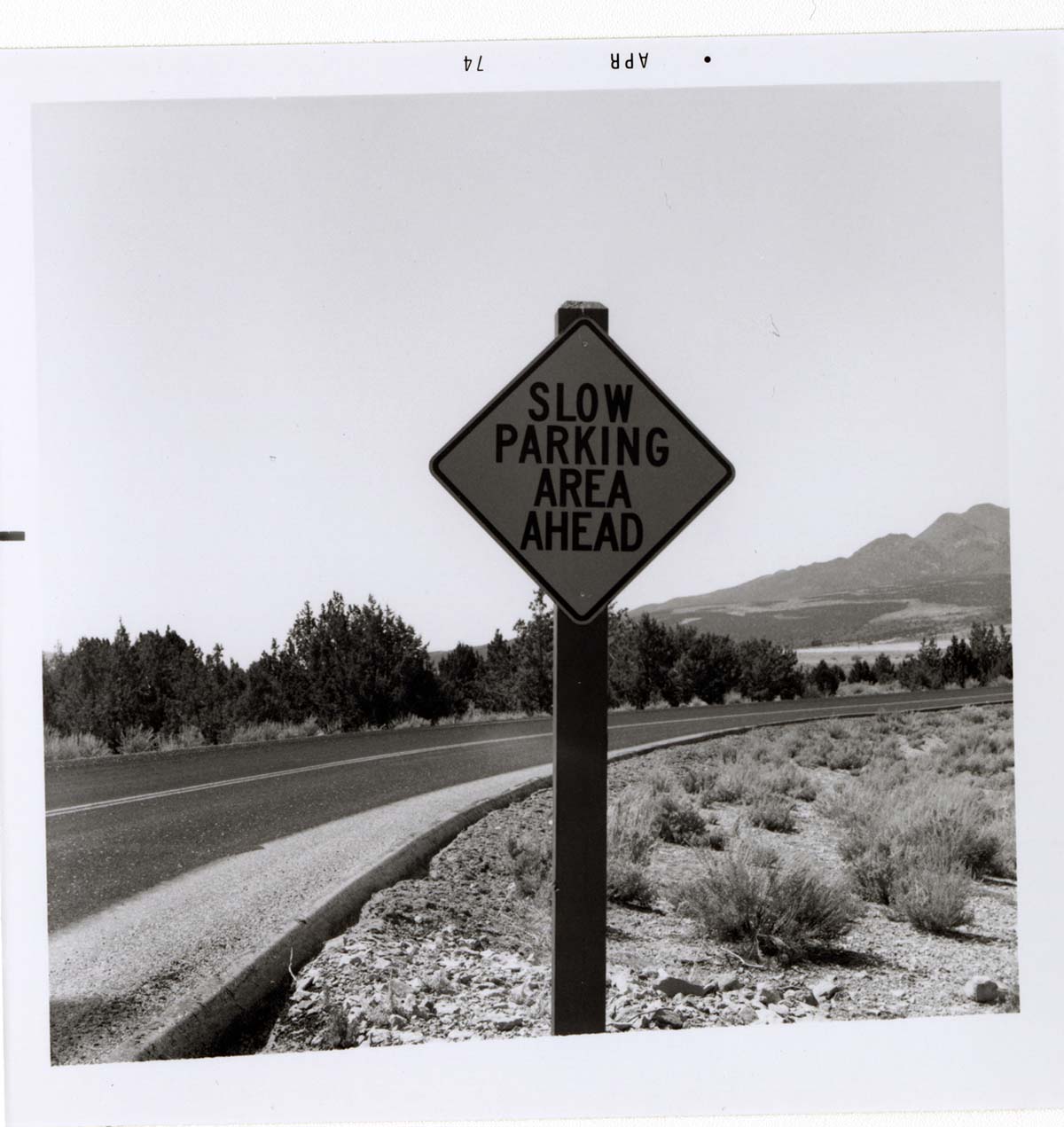 Road sign reading 'Slow Parking Area Ahead' in Kolob Canyon.