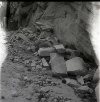 Rock and rubble piles at base of canyon wall, horse standing at far left. [Temple of Sinawava?]