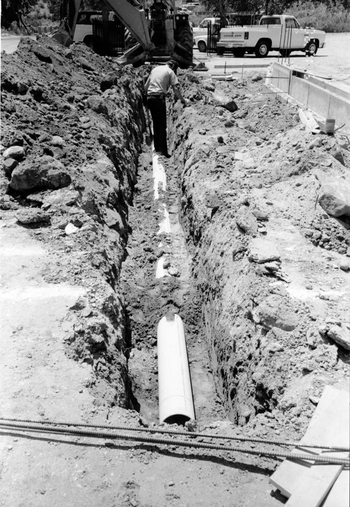 Man worker using shovel during the construction of headquarters addition.