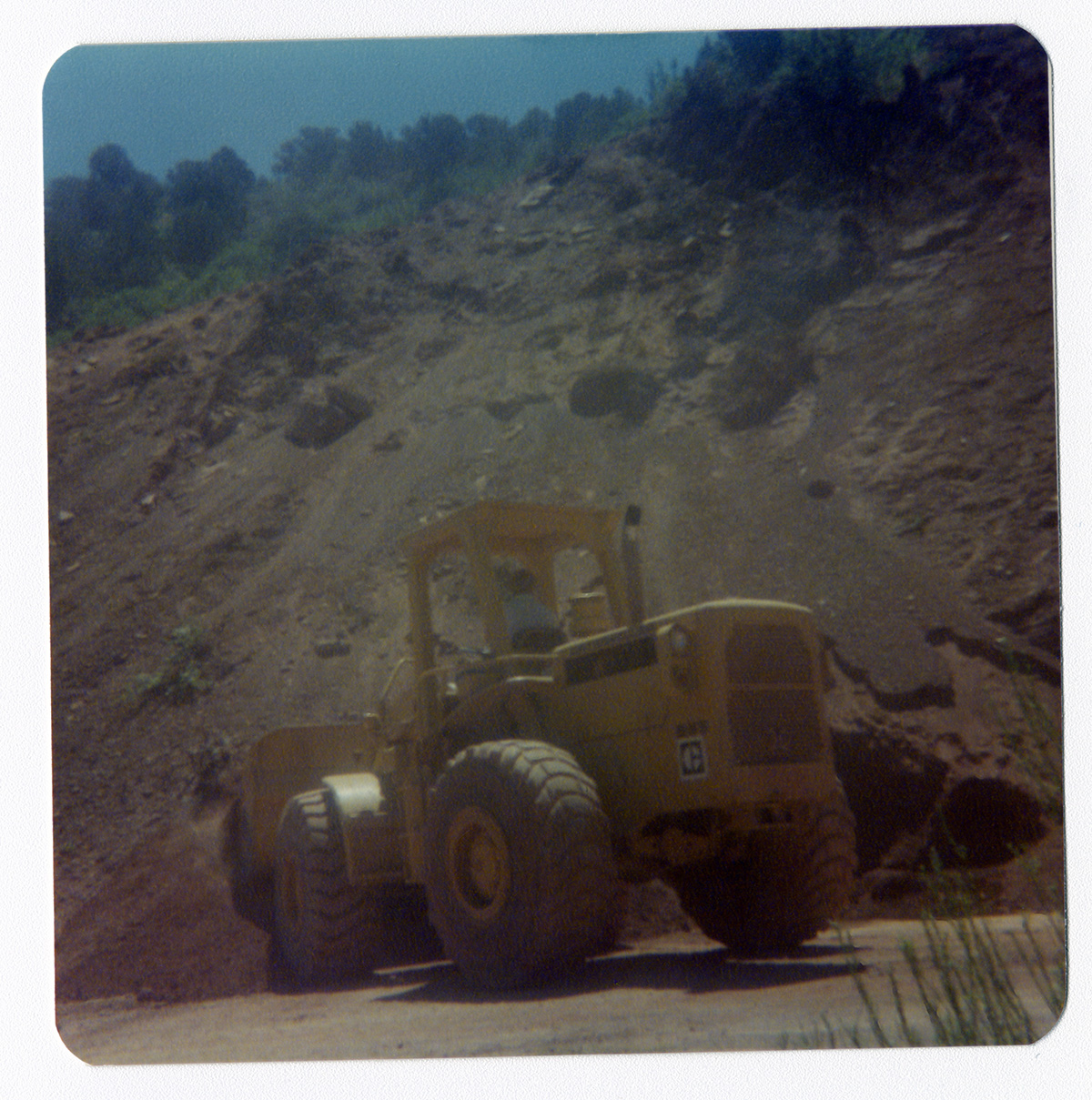 Excavator clearing debris for road work in Kolob Canyon.