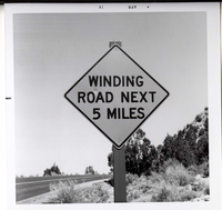 Road sign reading 'Winding Road Next 5 Miles' in Kolob Canyon.